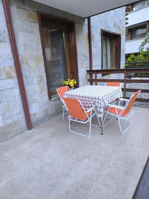 a table and chairs sitting on a patio at Mountain Heaven Retreat with free Bottle of Wine close to Gondola, free Parking in Bansko