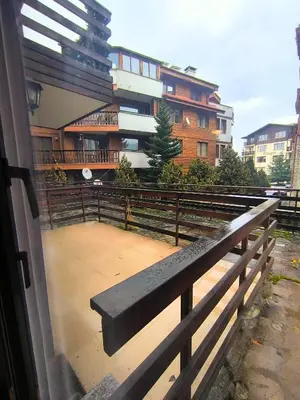 a bench sitting in front of a building at Mountain Heaven Retreat with free Bottle of Wine close to Gondola, free Parking in Bansko