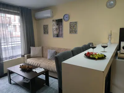 a living room with a couch and a table with a bowl of fruit at Mountain Heaven Retreat with free Bottle of Wine close to Gondola, free Parking in Bansko