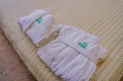 a pair of white sweaters sitting on a couch at Апартамент Пирин Apartment Pirin in Sandanski