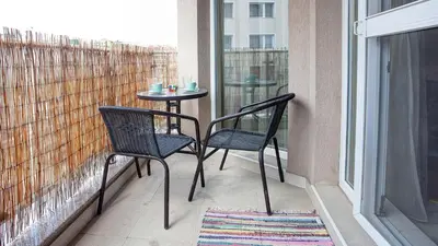 a balcony with two chairs and a table on a balcony at Elevated Living in Sofia