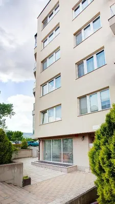 a tall white building with windows at Elevated Living in Sofia
