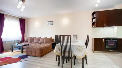 a living room with a table and a couch at Elevated Living in Sofia