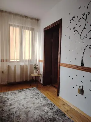 a living room with a door and a window at Къща за гости ФЪН ШУЙ 88 in Dobrinishte