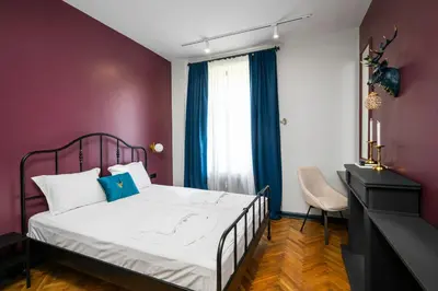 a bedroom with a bed and a purple wall at Royal Retreat - Your central designer spot by Flat Mаnager in Sofia