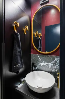 a bathroom with a white sink and a mirror at Royal Retreat - Your central designer spot by Flat Mаnager in Sofia