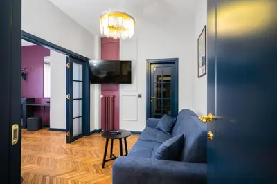a living room with a blue couch and a table at Royal Retreat - Your central designer spot by Flat Mаnager in Sofia