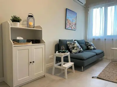 a living room with a blue couch and a table at Borisova Garden Skyline by Cosher in Sofia