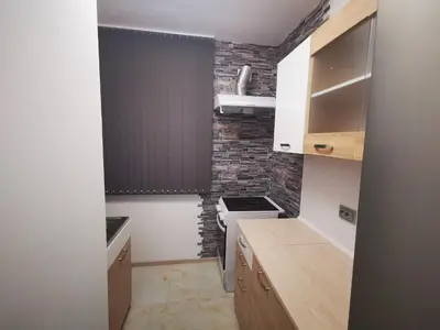 a small kitchen with a brick wall at Apartment 59 in Sofia