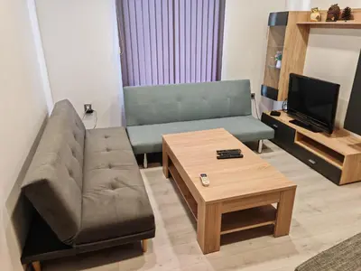 a living room with a couch and a coffee table at Apartment 59 in Sofia