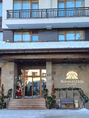 a building with a sign on the front of it at Cozy Studio in Semiramida Gardens - Borovets Hills 39 in Borovets