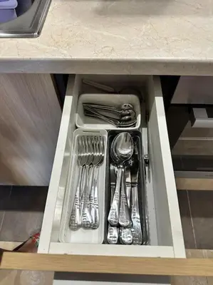 a drawer in a counter with utensils at Pirin Sky in Bansko