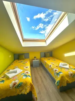 a room with two beds with a skylight at Pirin Sky in Bansko