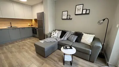 a living room with a couch and a table at Paradise Park Apartment Central Sofia Gem in Sofia
