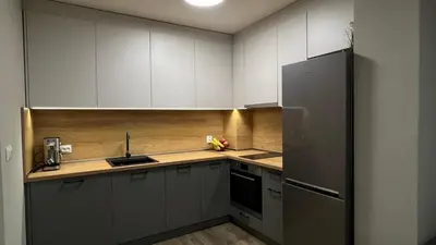a kitchen with white cabinets and a refrigerator at Paradise Park Apartment Central Sofia Gem in Sofia