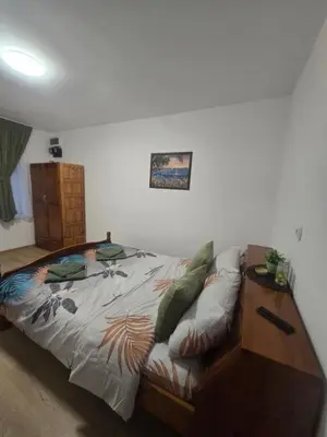 a large bed in a room with a couch at Къща за гости Кралимаркови Guest house Kralimarkovi in Devin