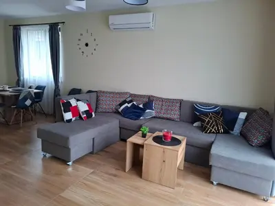 a living room with a couch and a table at Къщи за гости 