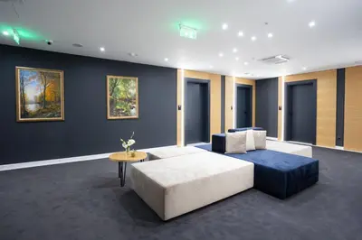 a living room with a couch and a table at Blue Star Luxury Hotel in Sofia