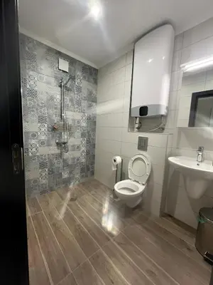 a bathroom with a shower and a toilet and a sink at goHOME Plovdiv-apartments and studio in Plovdiv