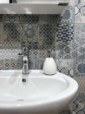 a bathroom sink with a soap dispenser on it at goHOME Plovdiv-apartments and studio in Plovdiv