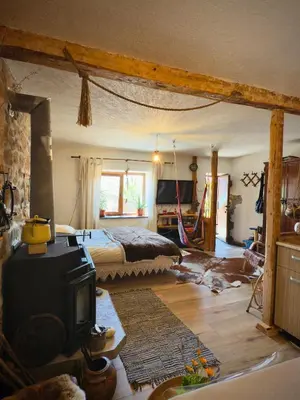 a bedroom with a bed and a tv in it at Books Houses in Beden