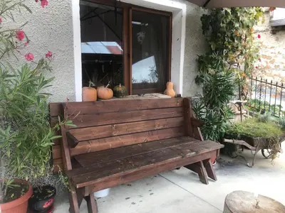 a wooden bench sitting in front of a window at Books Houses in Beden