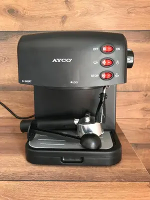 a black espresso machine sitting on top of a table at Boutique house in Devin