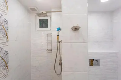 a bathroom with a shower with a glass door at Central St Vitosha Apartment in Sofia
