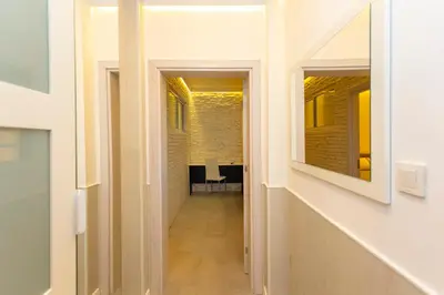a hallway in a building with a hallway leading into a room at Central St Vitosha Apartment in Sofia