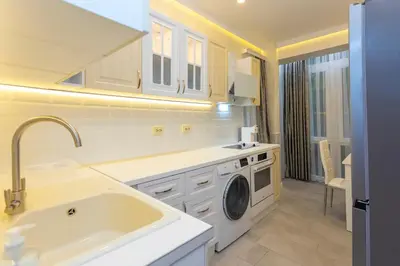 a kitchen with a sink and a washing machine at Central St Vitosha Apartment in Sofia