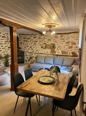 a table and chairs in a room with a couch at Beautiful Villa in the Rodopi Mountains in Narechen