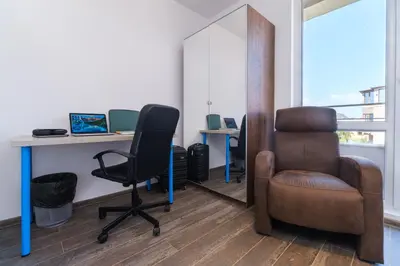 an office with a chair and a desk with a laptop at Serene Luxe Oasis Retreat on the Outskirts by Flat Mаnager in Plovdiv