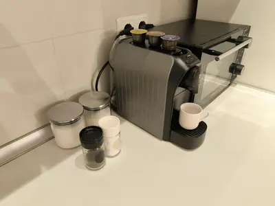 a coffee maker sitting on a counter with cups at Cozy 1 bdrm, top center, Solunska near Vitoshka street in Sofia