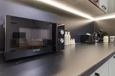 a microwave oven on a counter in a kitchen at Modern 1-Bedroom Apartment with Free Parking in Plovdiv