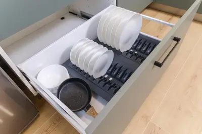 a drawer in a refrigerator filled with white dishes at Modern 1-Bedroom Apartment with Free Parking in Plovdiv