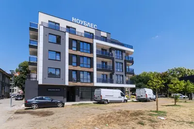 a building with cars parked in front of it at Modern 1-Bedroom Apartment with Free Parking in Plovdiv