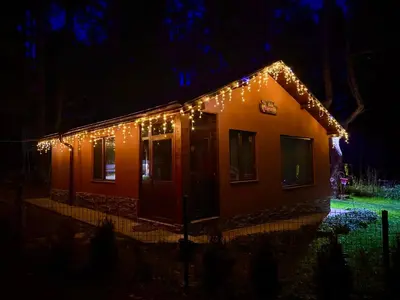 a house with christmas lights on it at night at Villa Capricorn in Tsigov Chark