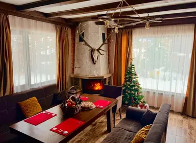 a living room with a christmas tree and a table at Villa Capricorn in Tsigov Chark