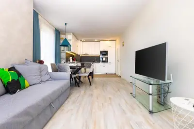 a living room with a couch and a flat screen tv at Bright and Cozy 1BD Flat in Plovdiv with Parking by Flat Mаnager in Plovdiv