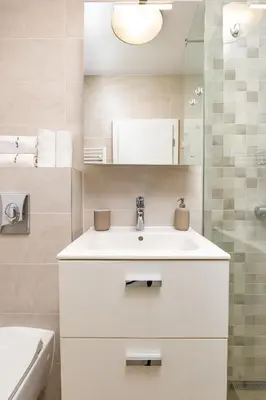 a white bathroom with a sink and a mirror at Bright and Cozy 1BD Flat in Plovdiv with Parking by Flat Mаnager in Plovdiv