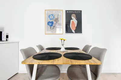 a dining room table with black cushions on it at 2 Private Suits - Art, Location, Quiet, Balconies in Sofia