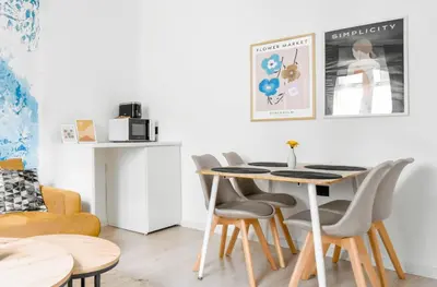 a dining room with a table and chairs at 2 Private Suits - Art, Location, Quiet, Balconies in Sofia