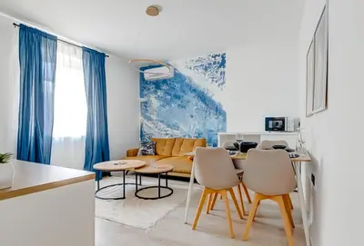 a kitchen and living room with a table and chairs at 2 Private Suits - Art, Location, Quiet, Balconies in Sofia