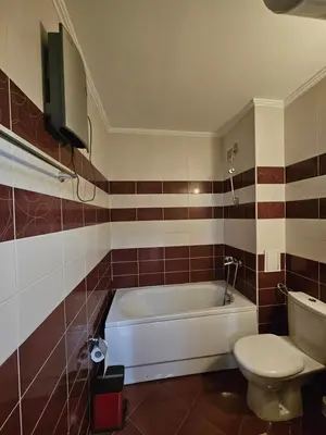 a bathroom with a white tub and a toilet at Частен Апартамент Пампорово Гранд Манастира 2Б5 in Pamporovo