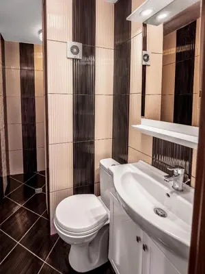 a bathroom with a white toilet and a sink at The Boulevard Luxury Apartment 2 in Sofia