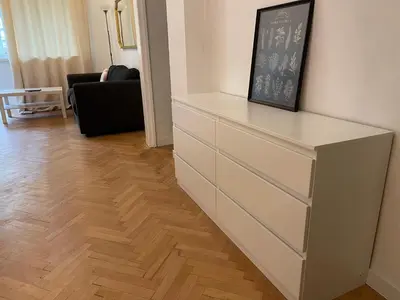 a chest of drawers in a living room at Levski studio at heart of Sofia in Sofia