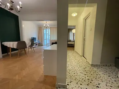a living room with a table and a dining room at Levski studio at heart of Sofia in Sofia
