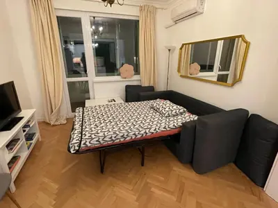 a living room with a couch and a table at Levski studio at heart of Sofia in Sofia