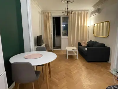 a living room with a table and a couch at Levski studio at heart of Sofia in Sofia