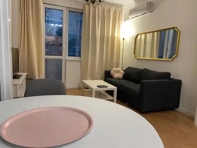 a living room with a table and a couch at Levski studio at heart of Sofia in Sofia